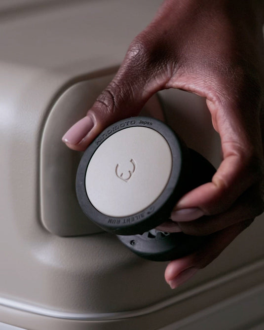 a hand holding a black and white circular object