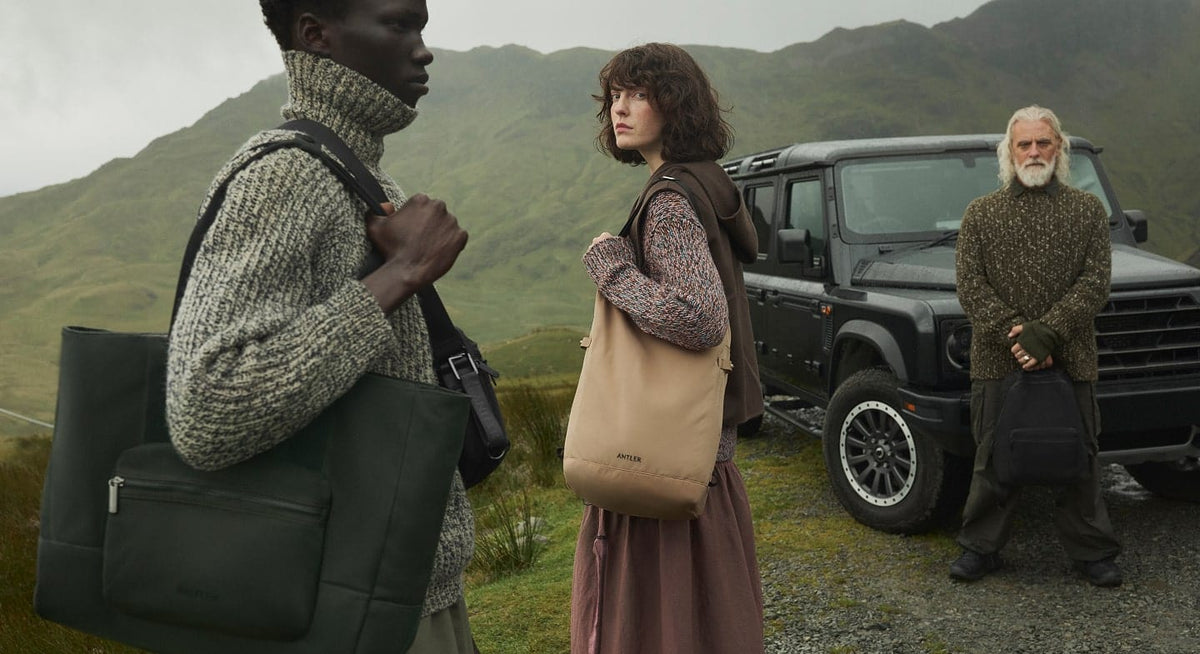 a man and woman standing in front of a jeep