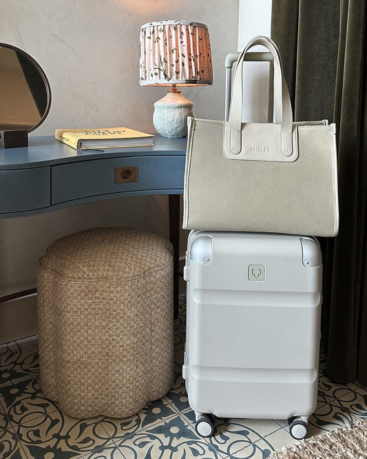 a white bag and a white bag on top of a blue table