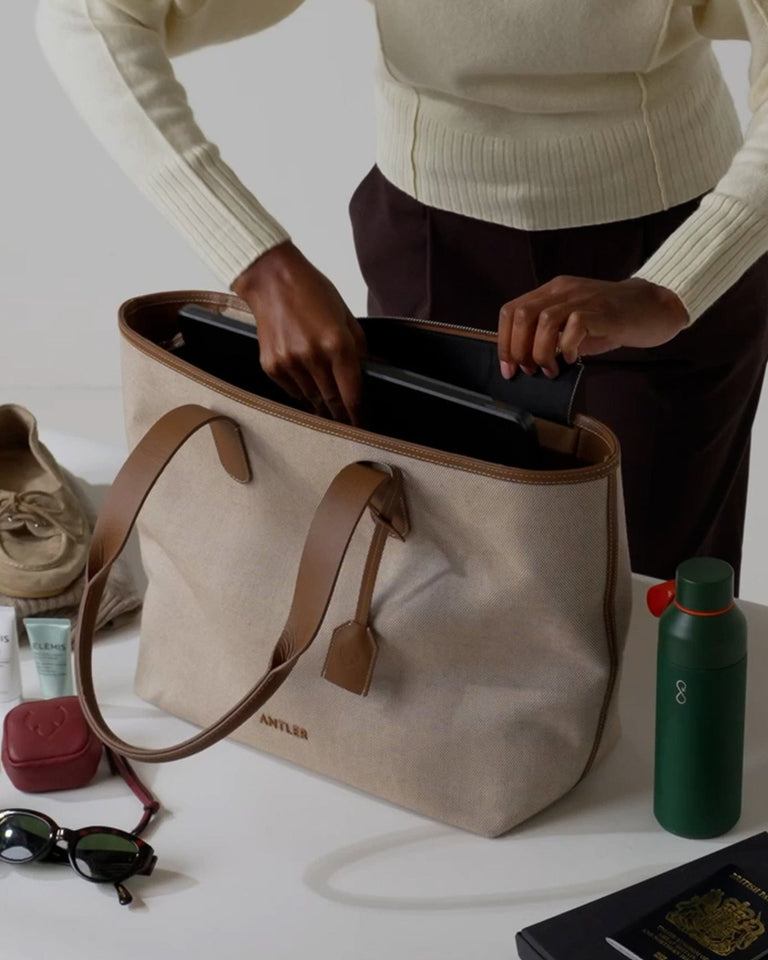 a person putting a laptop in a bag