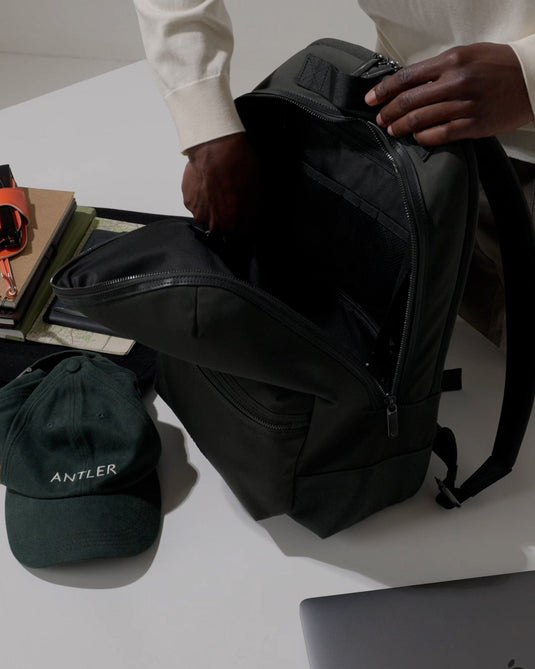 a person opening a backpack