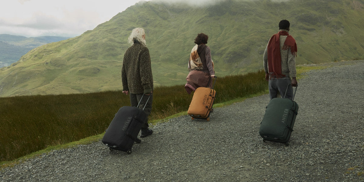 a group of people with luggage on a path