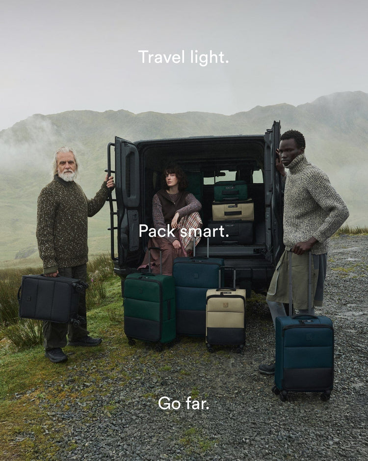 a group of people standing next to a van with luggage