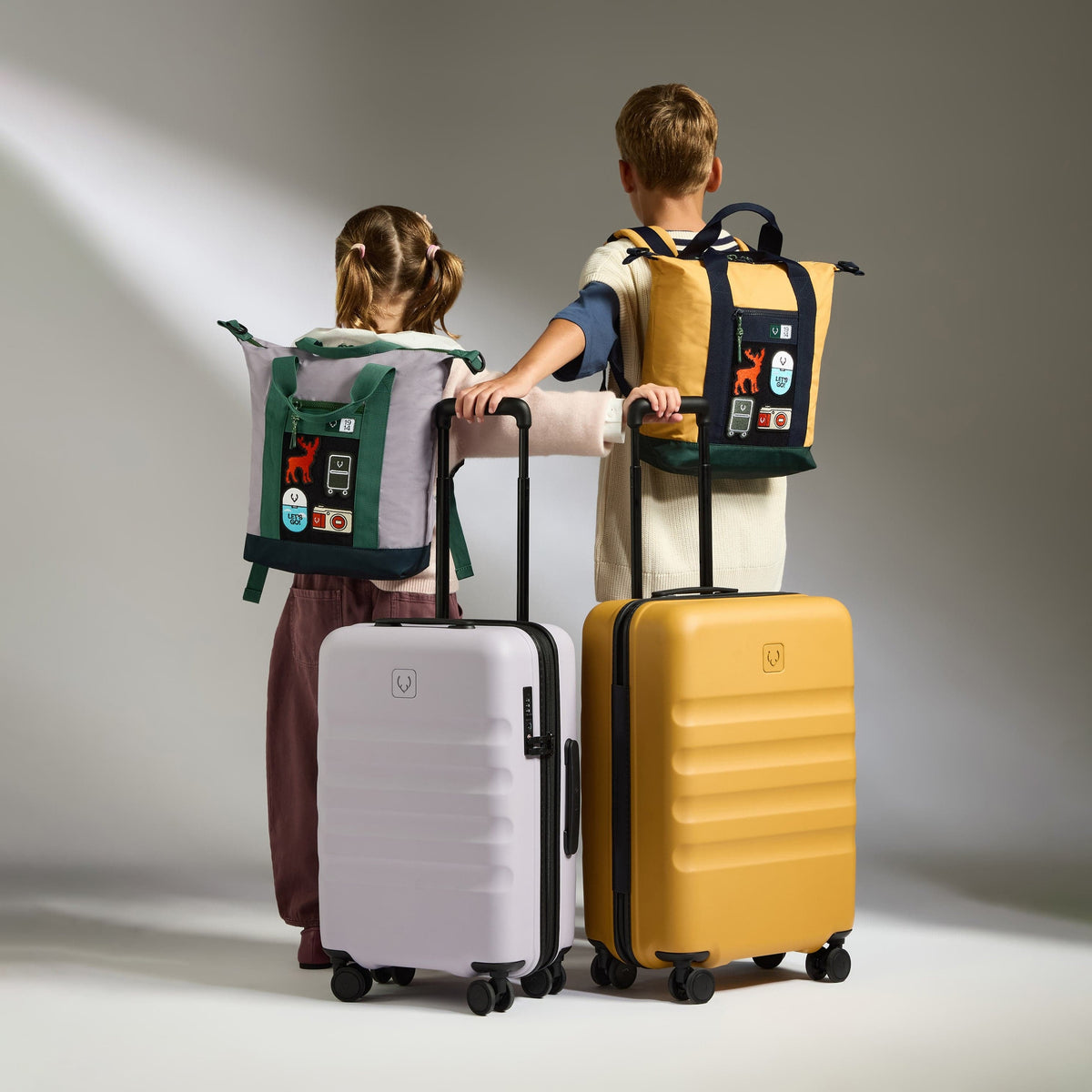 a boy and girl with luggage