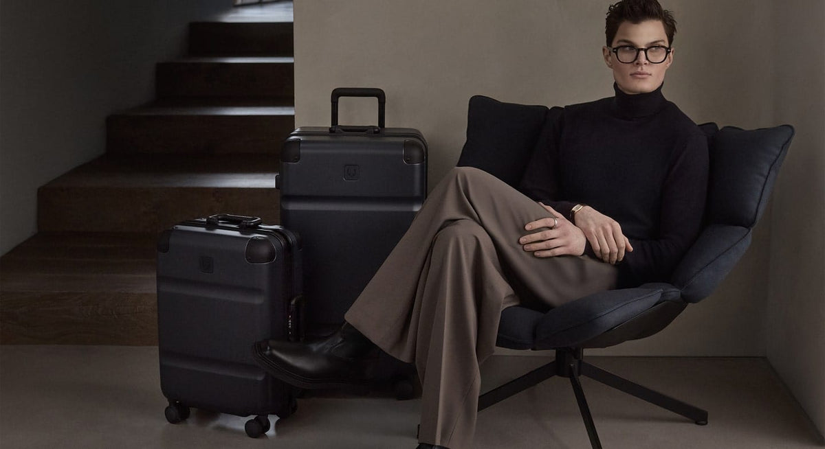 a woman sitting in a chair with luggage