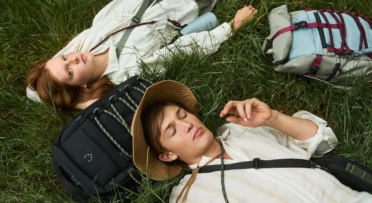 a man and woman lying in the grass