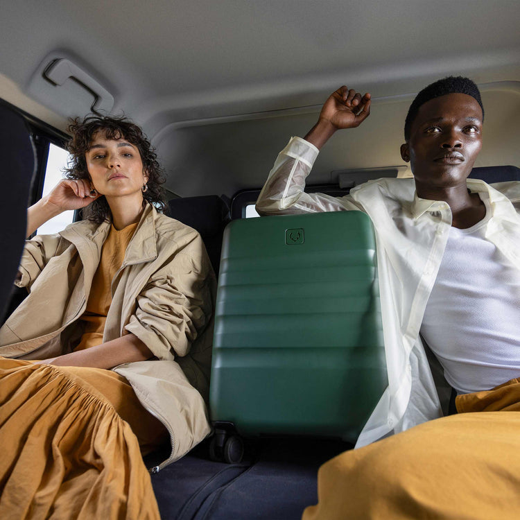 a man and woman sitting in a car