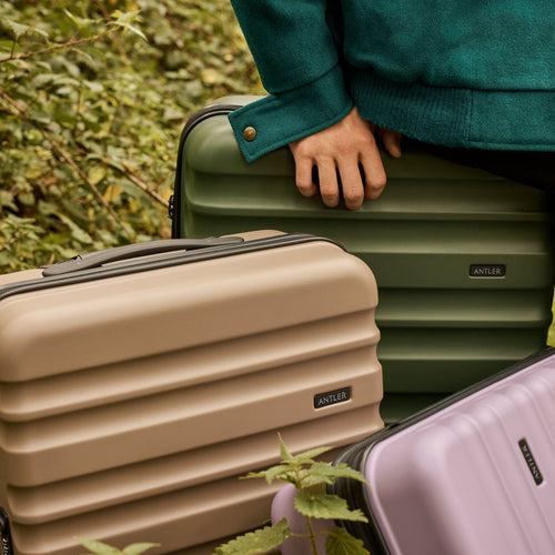 a person holding luggage in the woods