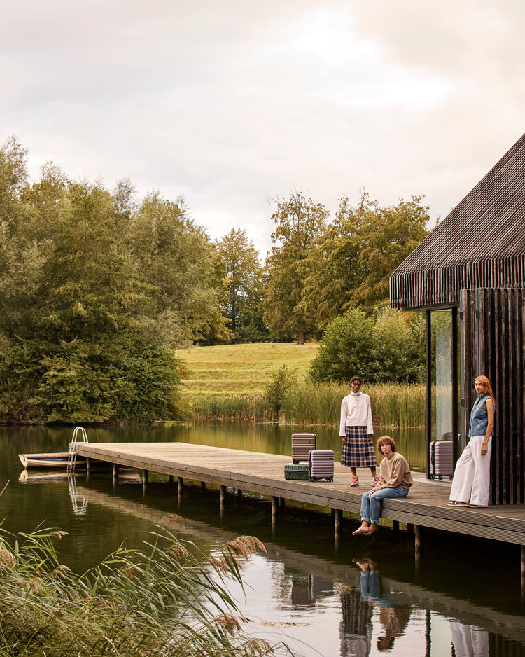 a group of people sitting on a dock near a lake