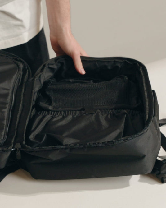 a person holding a black bag