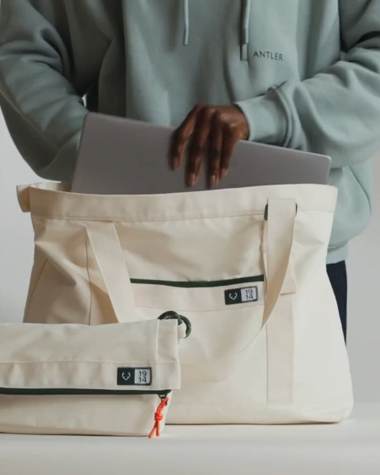 a person with a laptop in a bag