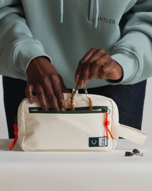 a person opening a small white bag