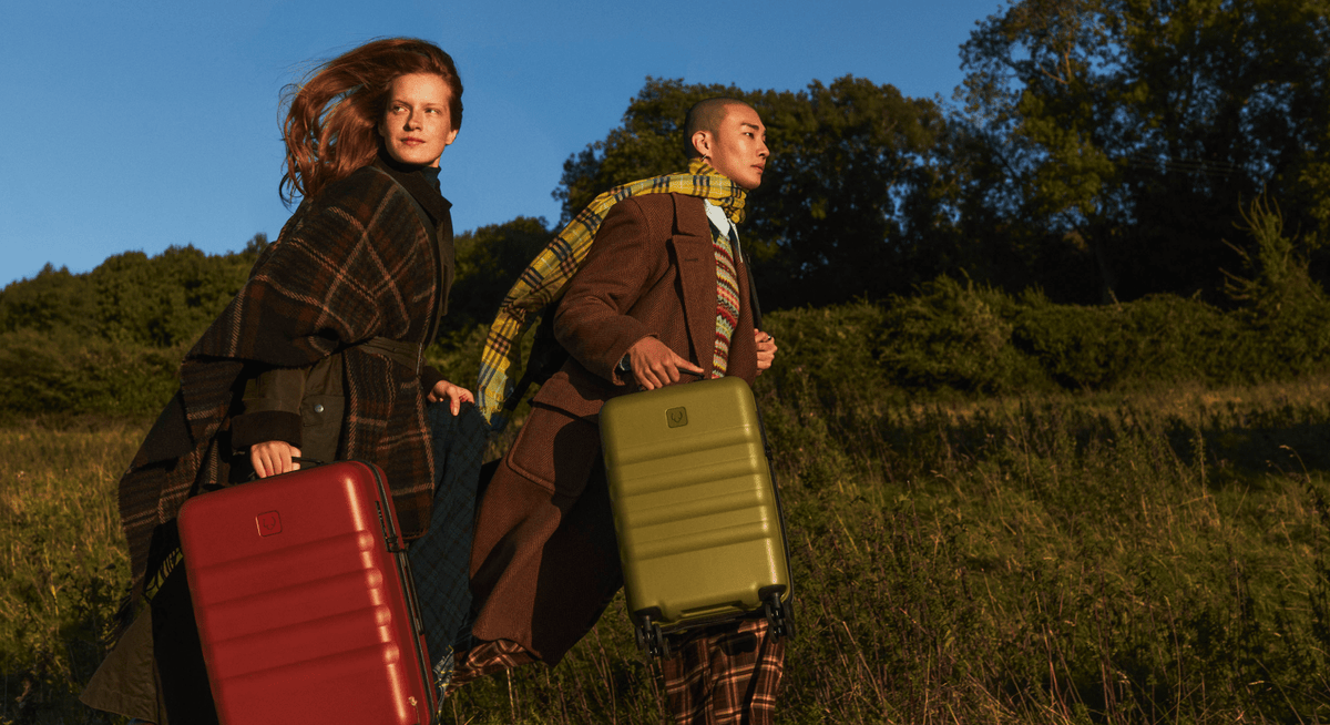a man and woman carrying luggage