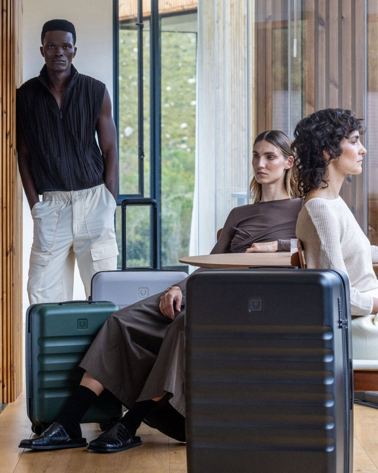 a group of people sitting at a table with luggage