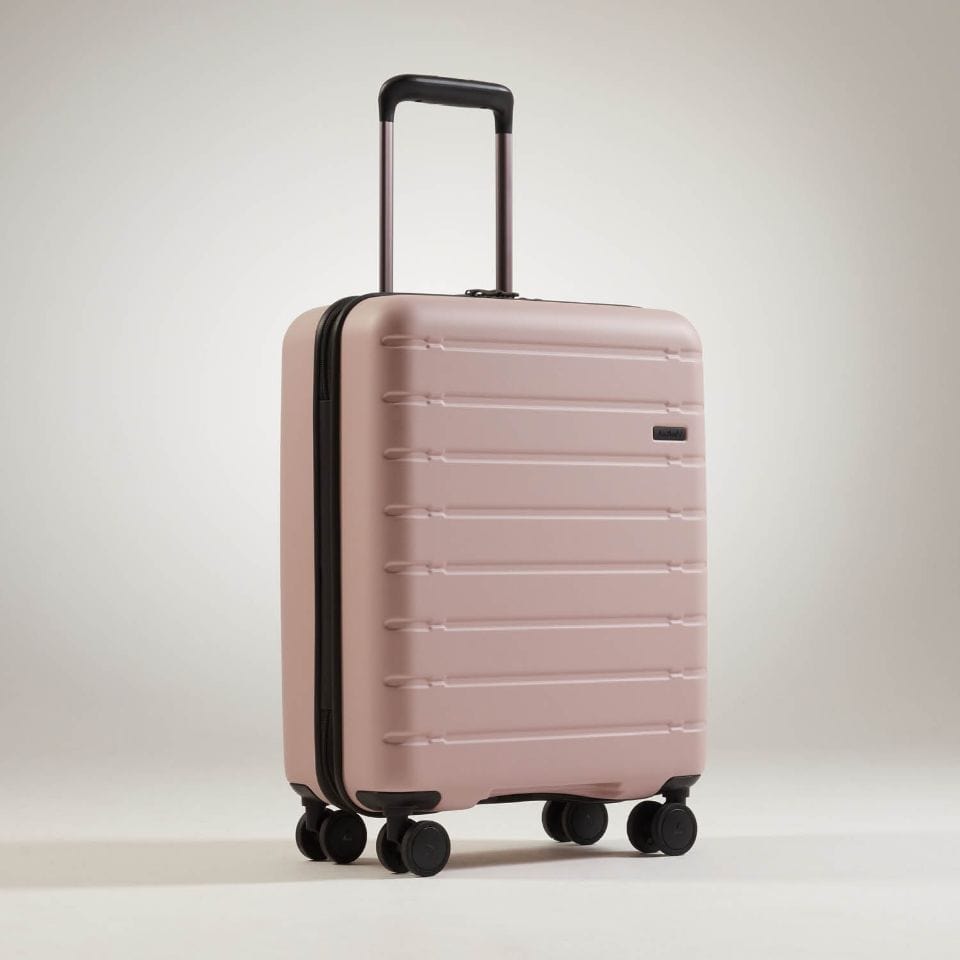 a pink suitcase with wheels