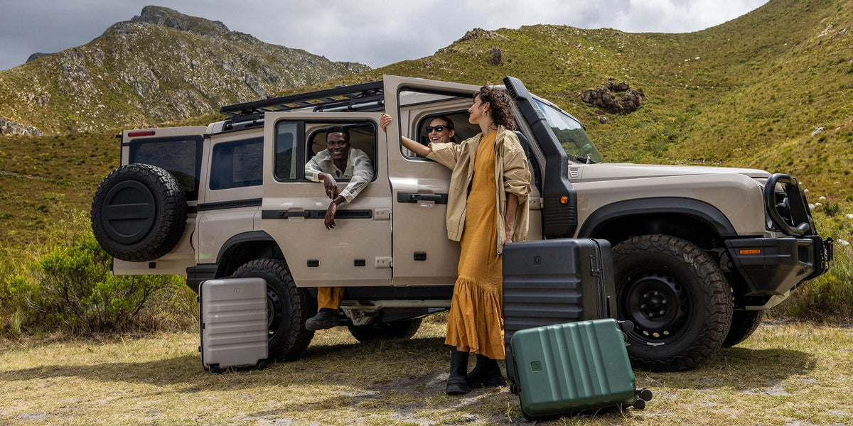 a group of people standing in the back of a car with luggage