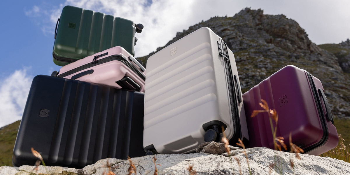 a group of luggage on a rocky hill
