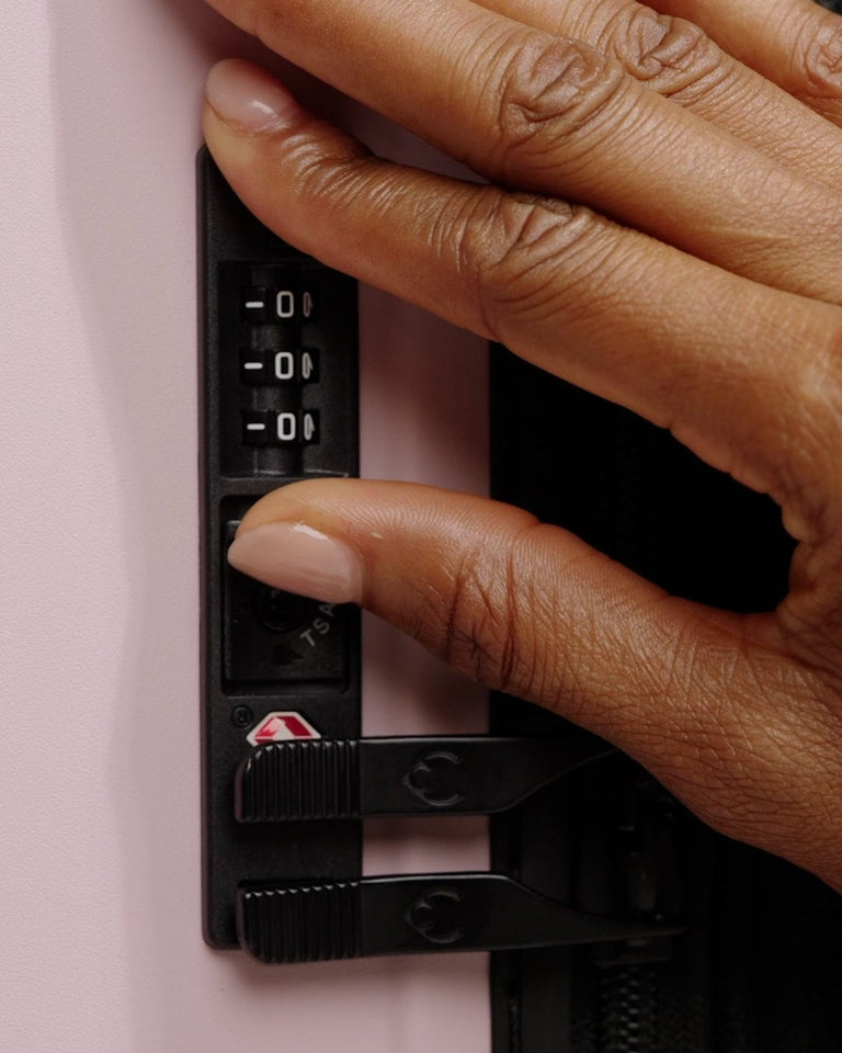 a hand holding a black object with a number on it