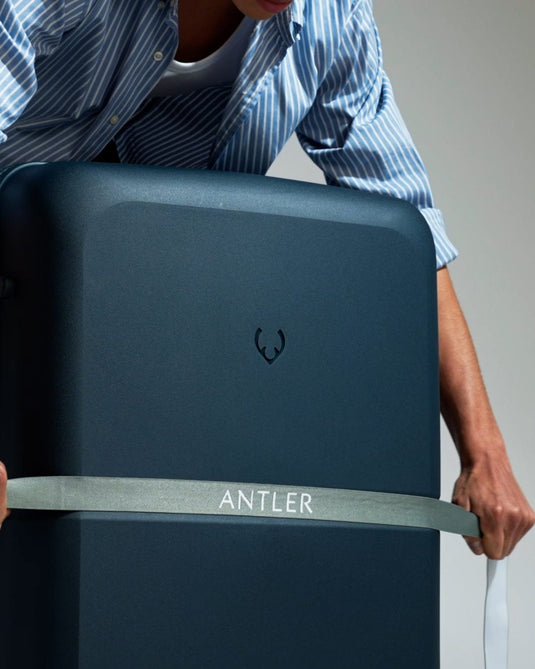 a person holding a large suitcase