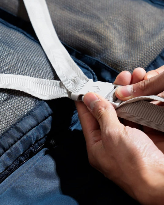 a person's hands fastening a seat belt