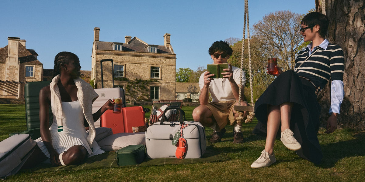 a group of people sitting on a swing with luggage