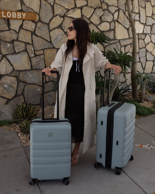 a woman standing next to luggage