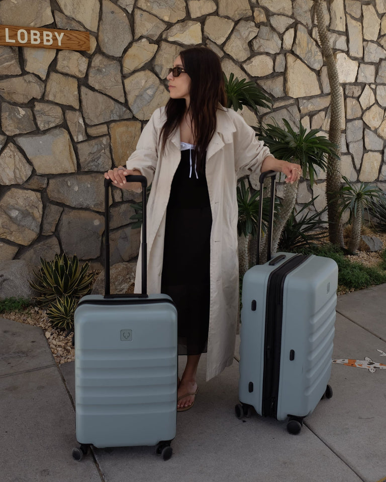 a woman standing next to luggage