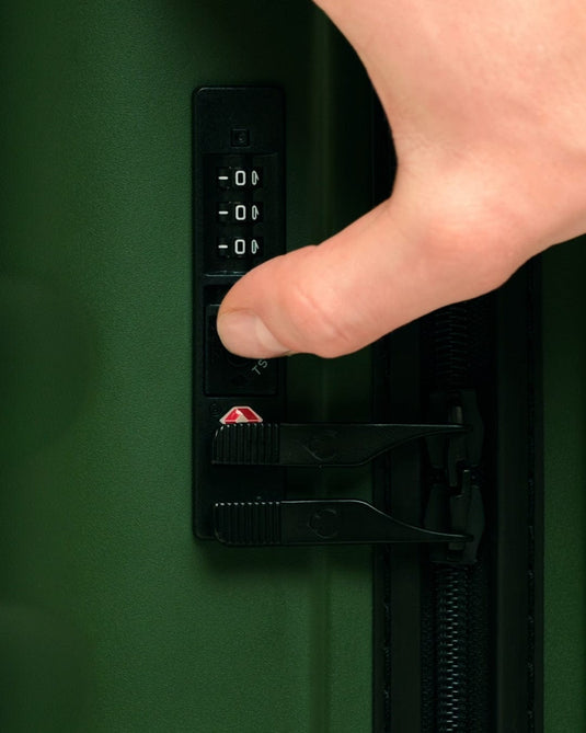 a finger pressing a code on a safe