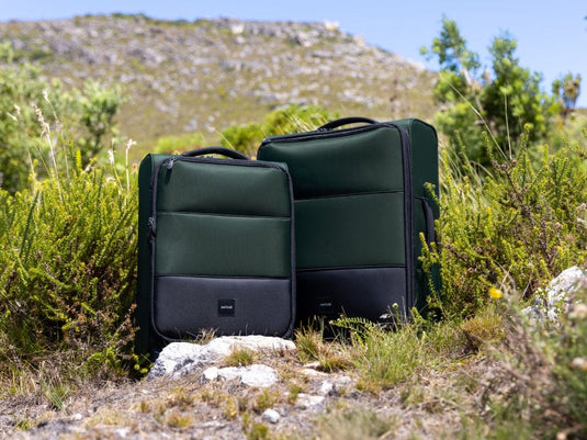 two suitcases in the grass