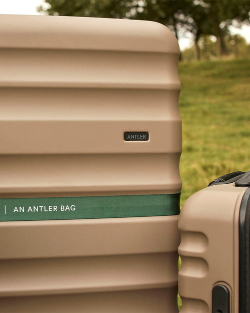 a brown suitcase with a green band around it