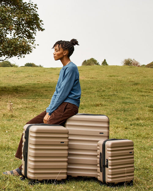 a woman sitting on top of luggage