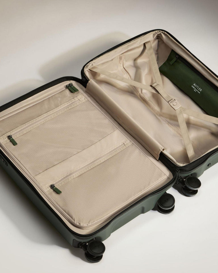 a suitcase with wheels and a green cover
