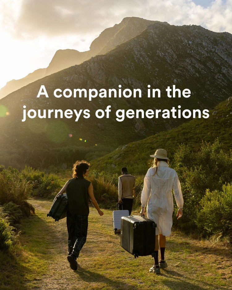 a group of people walking on a path with luggage