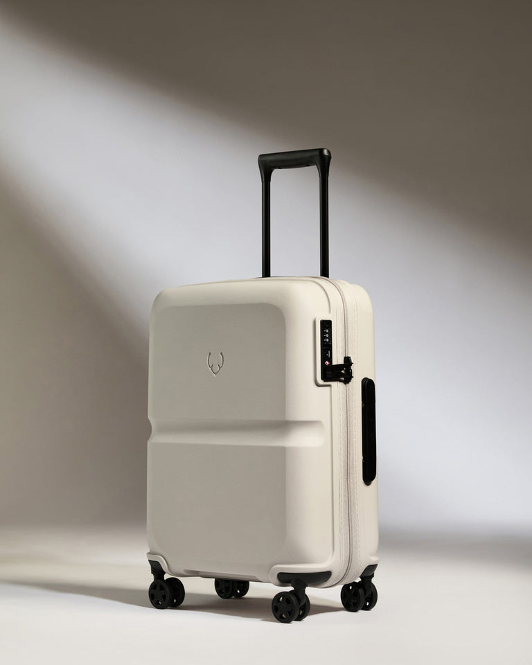 a white suitcase with black wheels